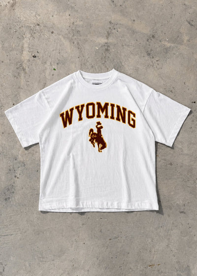 White | White t-shirt with 'Wyoming' and a logo on a concrete floor