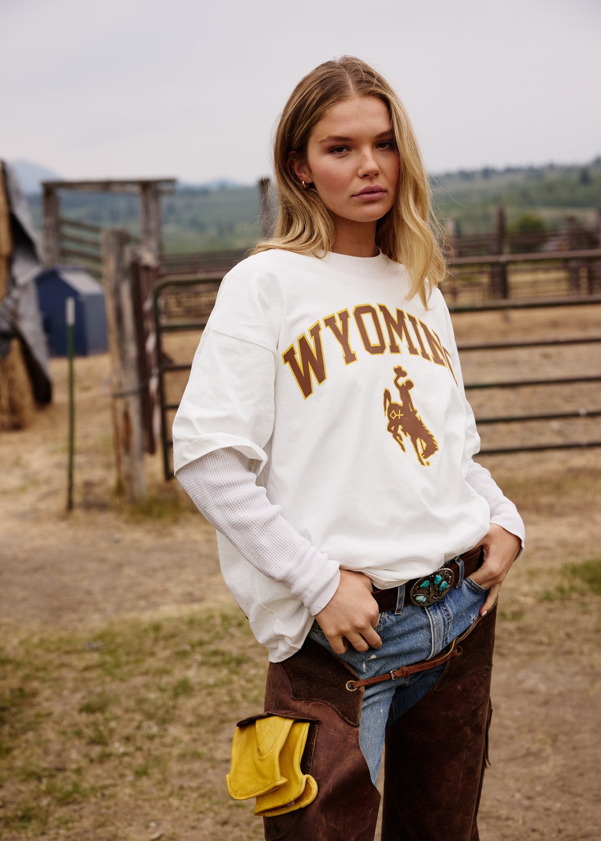 White | White t-shirt with 'Wyoming' and a logo on a concrete floor