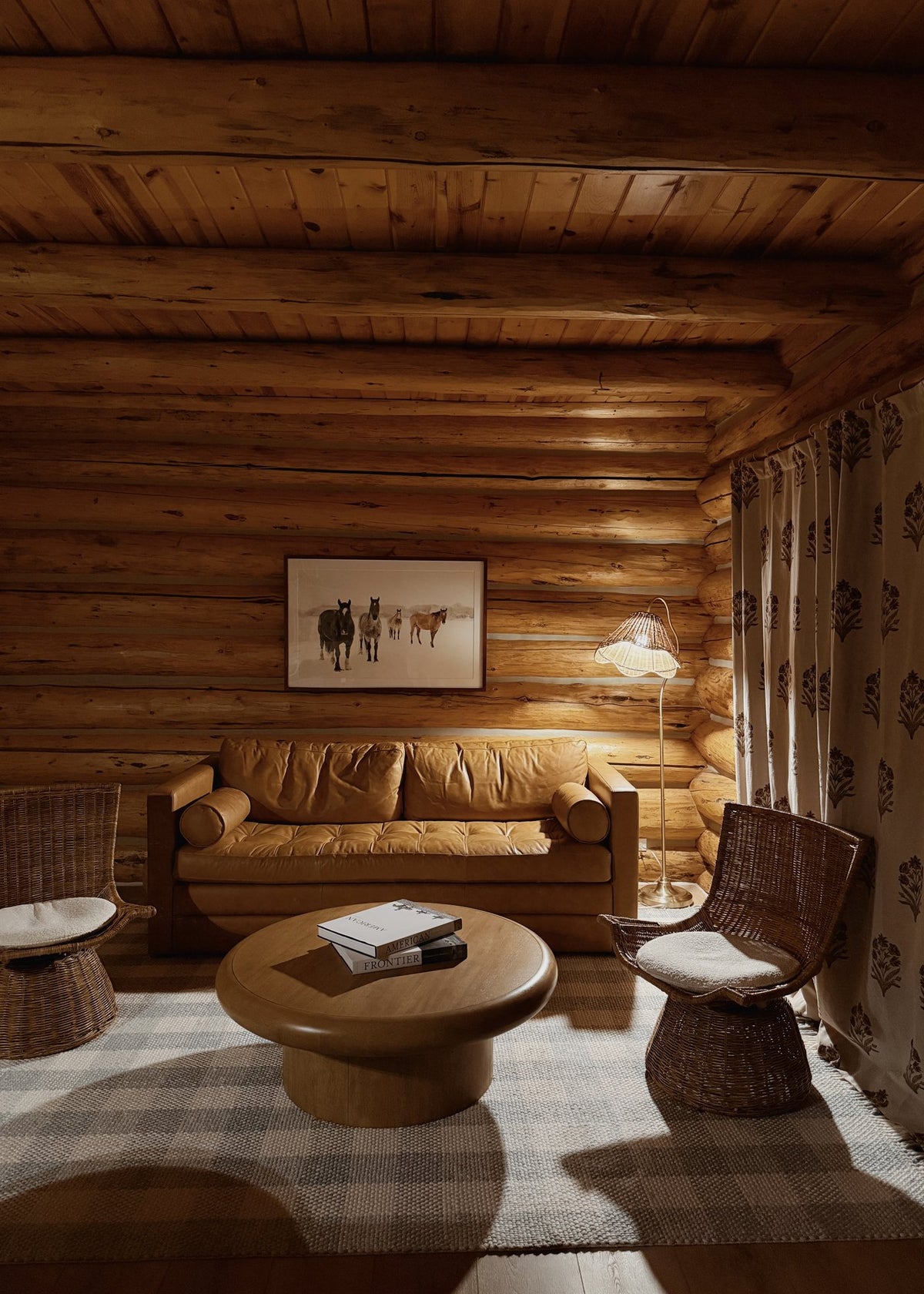 Living room with a leather sofa in a renovated Teton Cabin