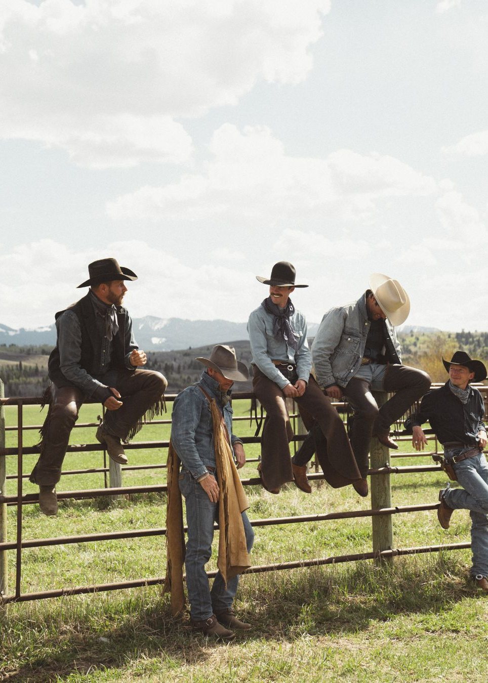 The Diamond Cross cowboys on the corral fence