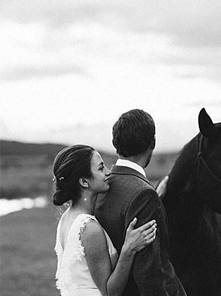 Couple embracing beside a horse at Diamond Cross Ranch